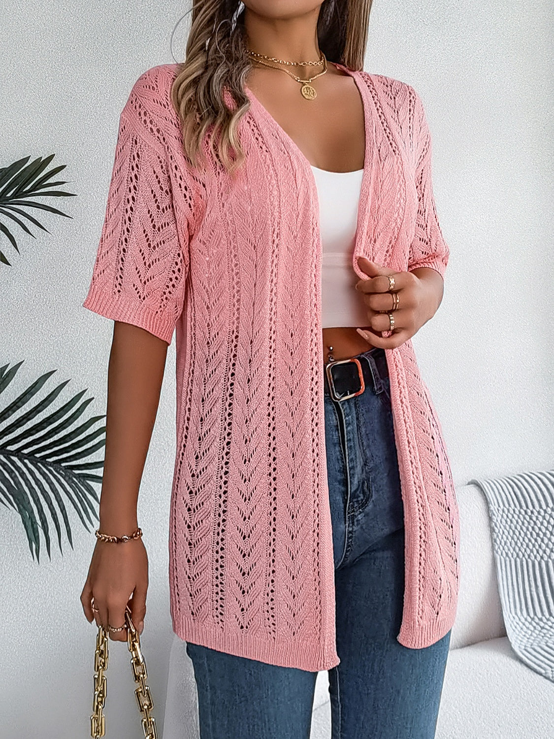 Pink open-knit chevron sleeve cardigan with V-neck and short sleeves.