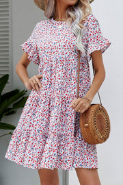 Miniature floral tiered babydoll dress with short flutter sleeves and a ruffled hem.