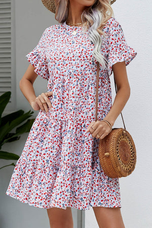 Miniature floral tiered babydoll dress with short flutter sleeves and a ruffled hem.