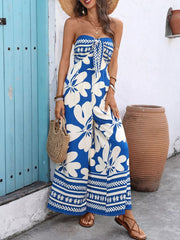 Strapless wide-leg romper in royal blue with white floral print and tie-front detail.