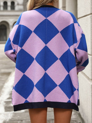 Argyle knit oversized cardigan in pink purple and blue with black trim.