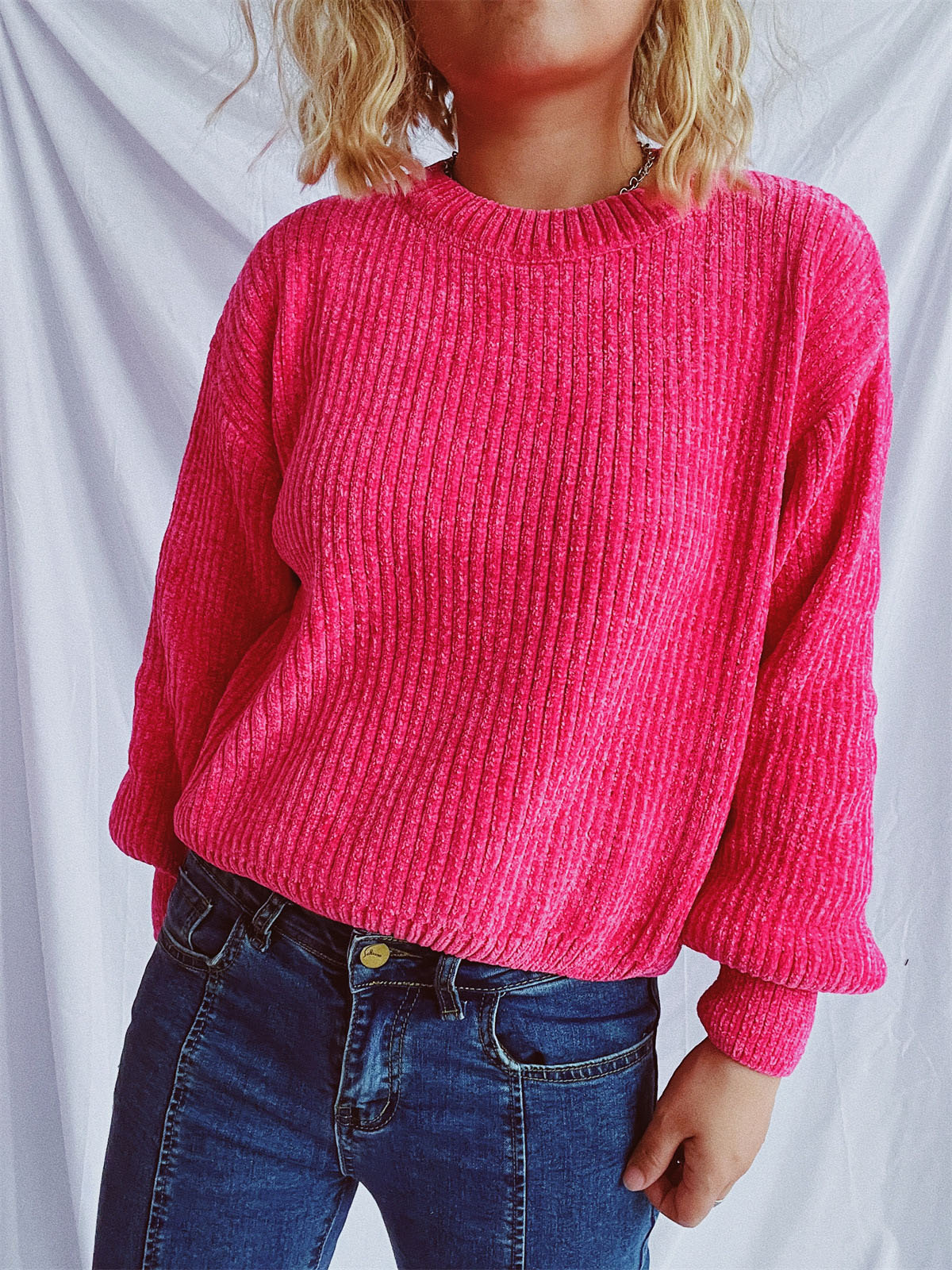 Textured ribbed knit crewneck pullover sweater in bright pink with relaxed fit.