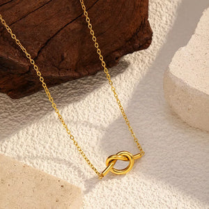 Gold-plated knot pendant necklace with delicate chain