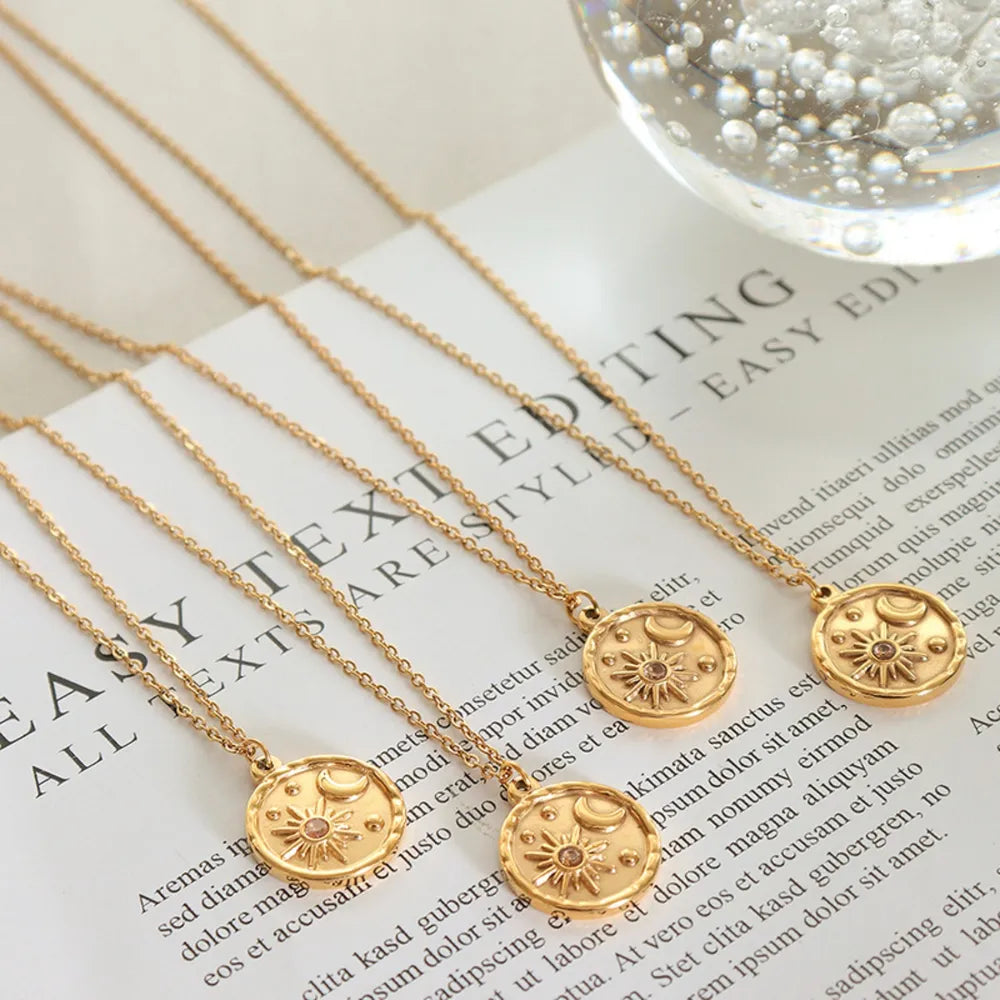 Gold zirconia coin necklace with sun and moon design
