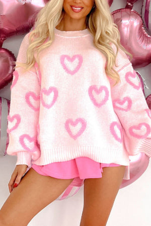 Pink knit sweater with heart appliqué and balloon sleeves.
