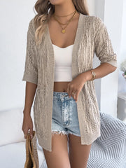 Tan open-knit three-quarter sleeve cardigan with cable knit texture and airy open weave.