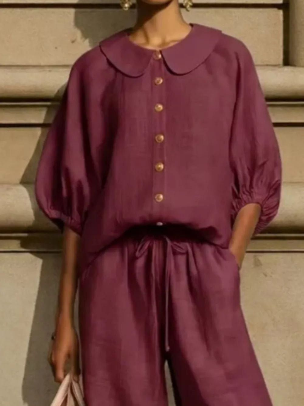 Burgundy two-piece set with button-down top and drawstring pants.