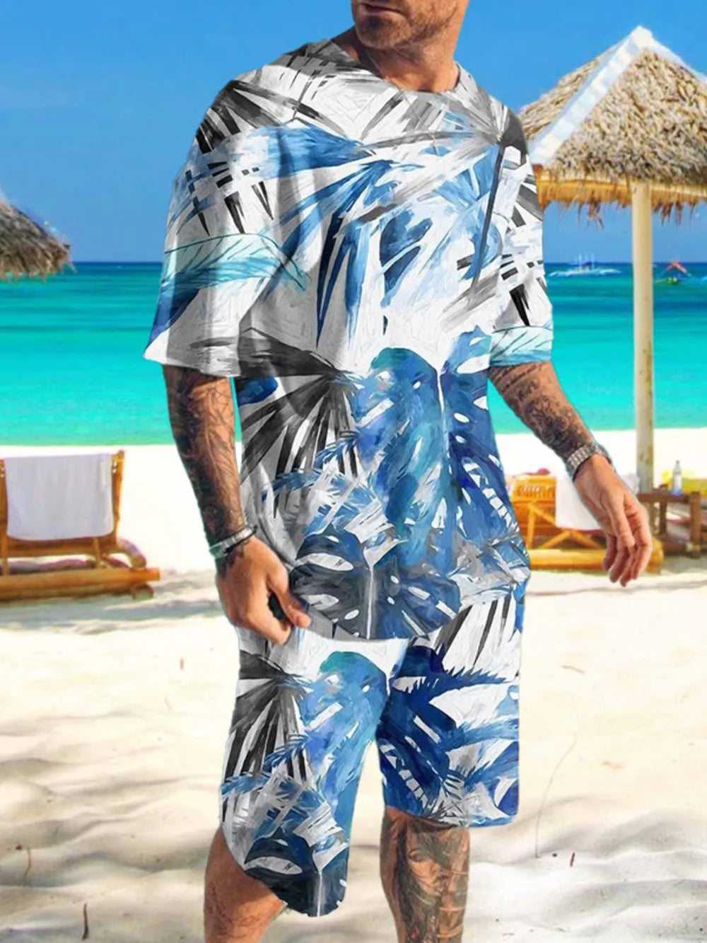 Men's two-piece set with blue and white tropical leaf print, crew neck t-shirt and shorts.