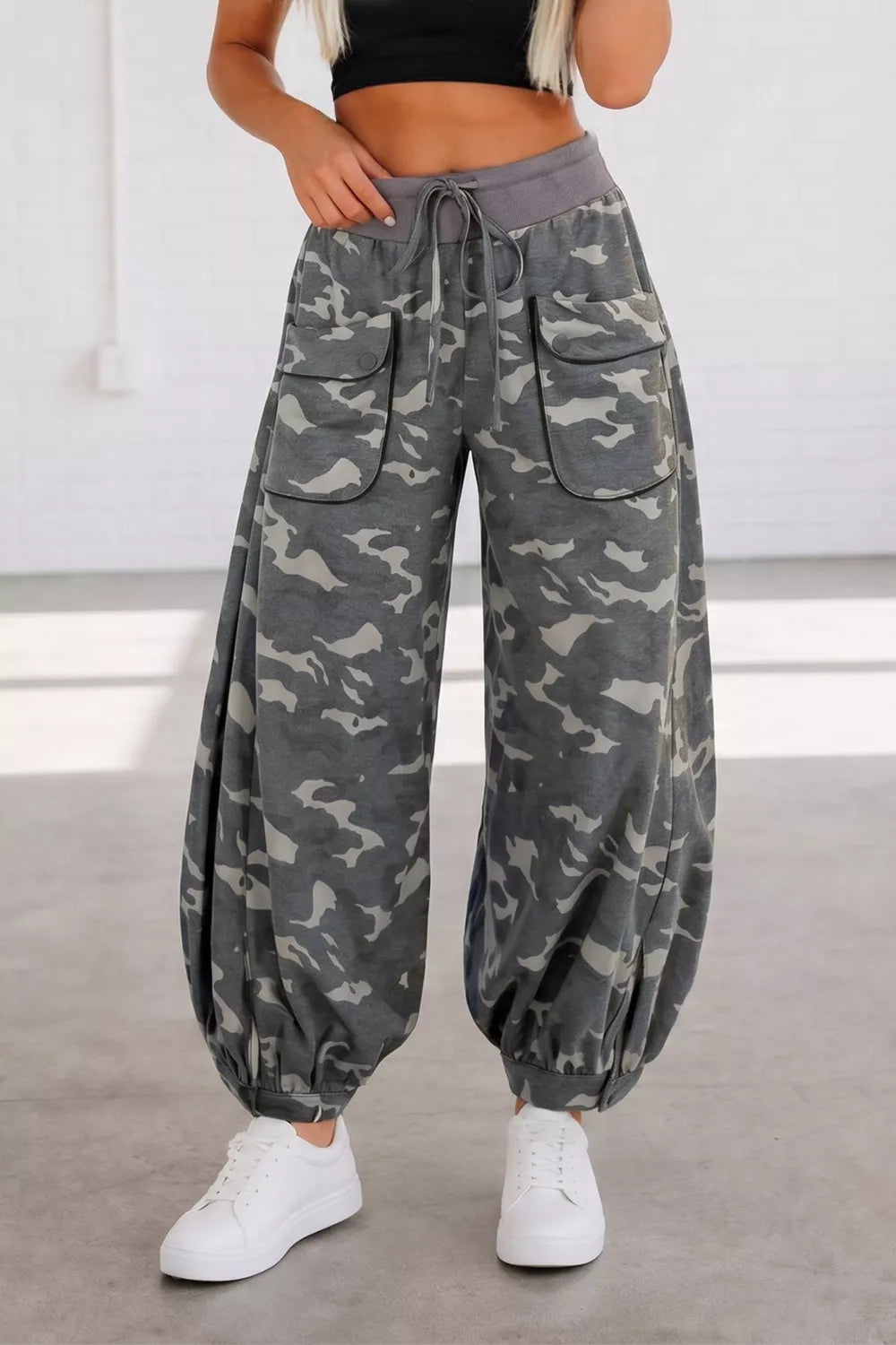 Camouflage barrel pants with cargo pockets and drawstring waist.
