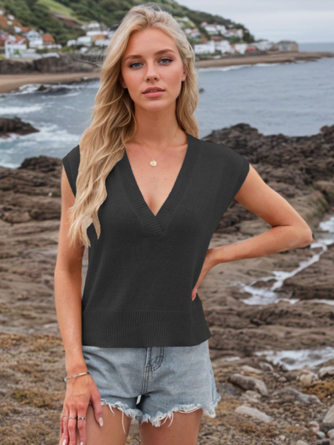 Black knit V-neck sleeveless sweater top with ribbed trim