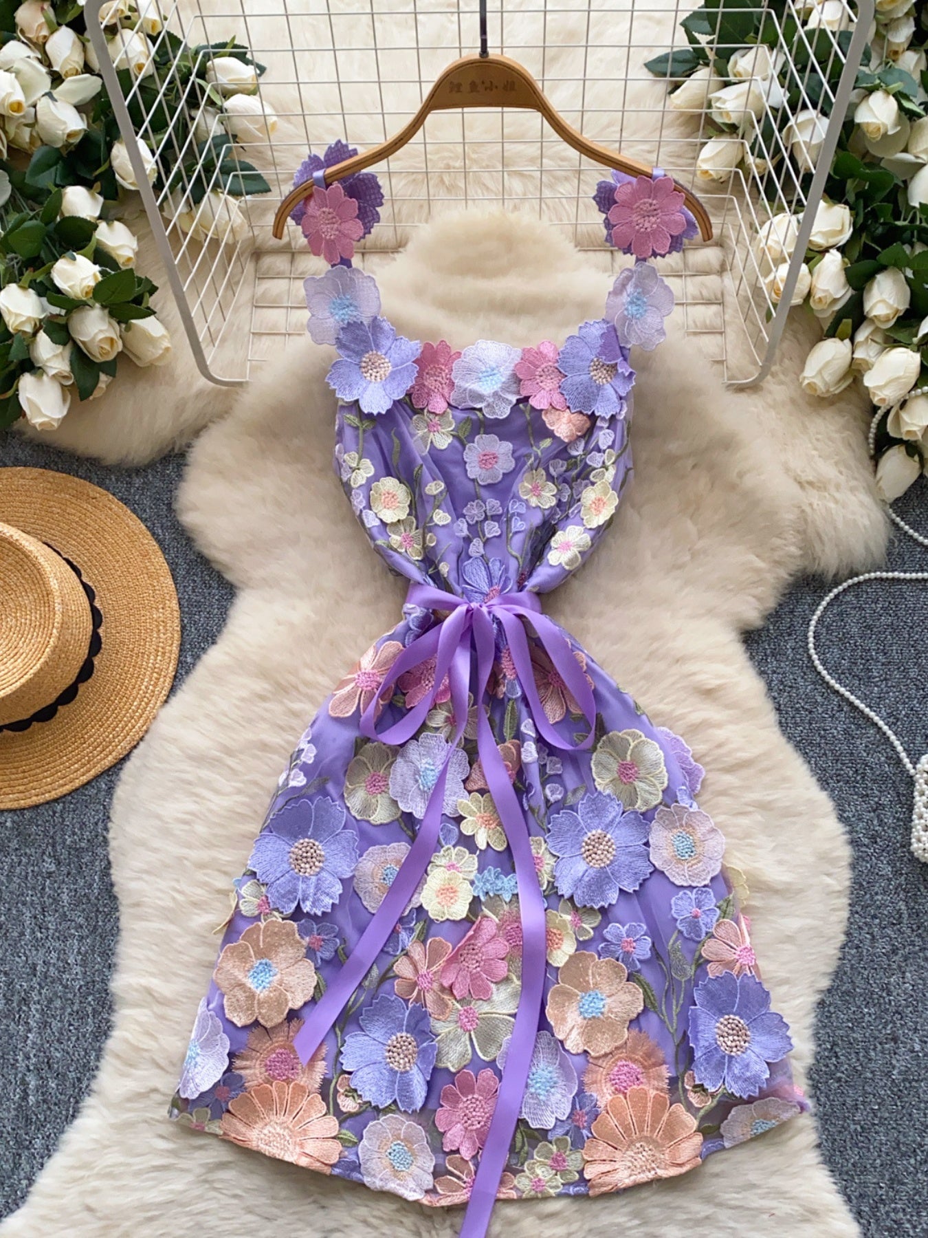 Purple embroidered floral mini dress with ribbon tie and applique flowers.