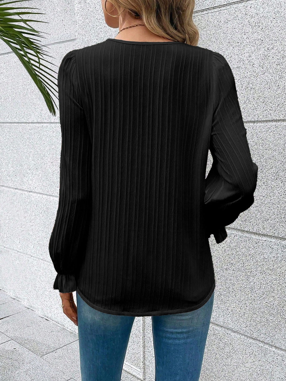 Black textured pleat blouse with lace trim cuffs and puff sleeves.