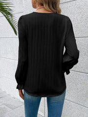 Black textured pleat blouse with lace trim cuffs and puff sleeves.
