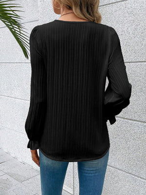 Black textured pleat blouse with lace trim cuffs and puff sleeves.