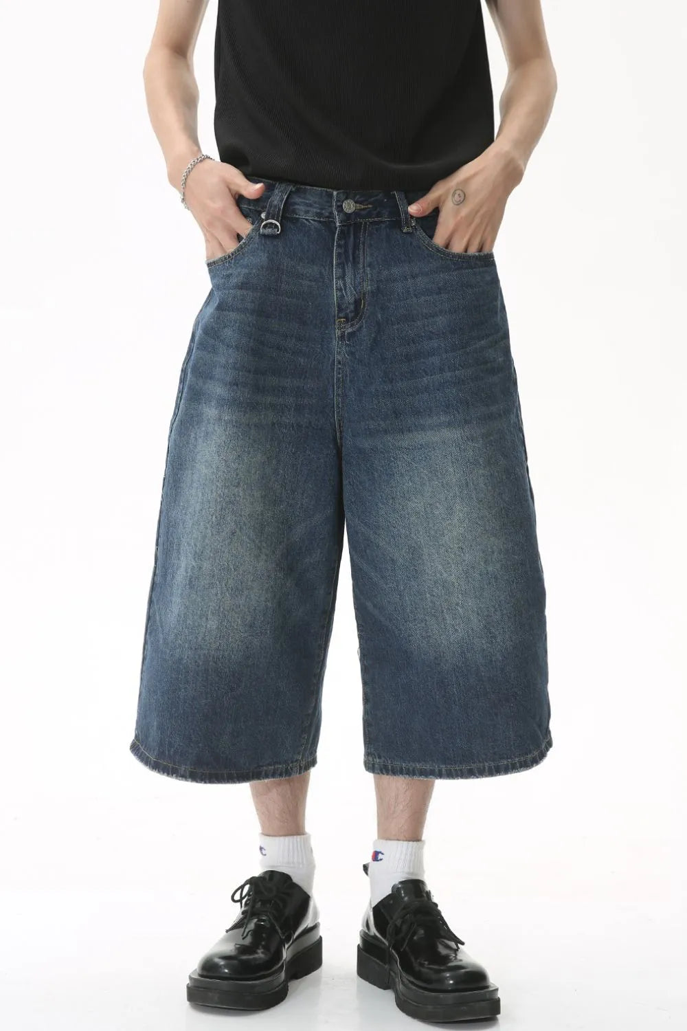 Wide-leg denim culottes in light blue with a relaxed fit and distressed details.