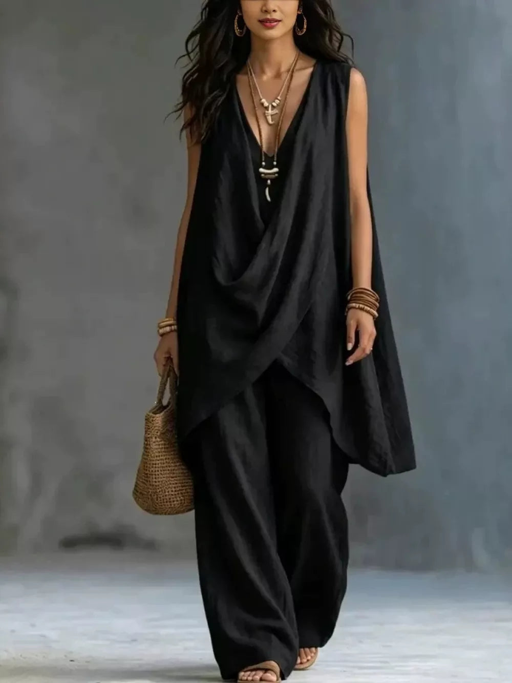 Black asymmetrical top and wide-leg pants set with deep V-neck and sleeveless design