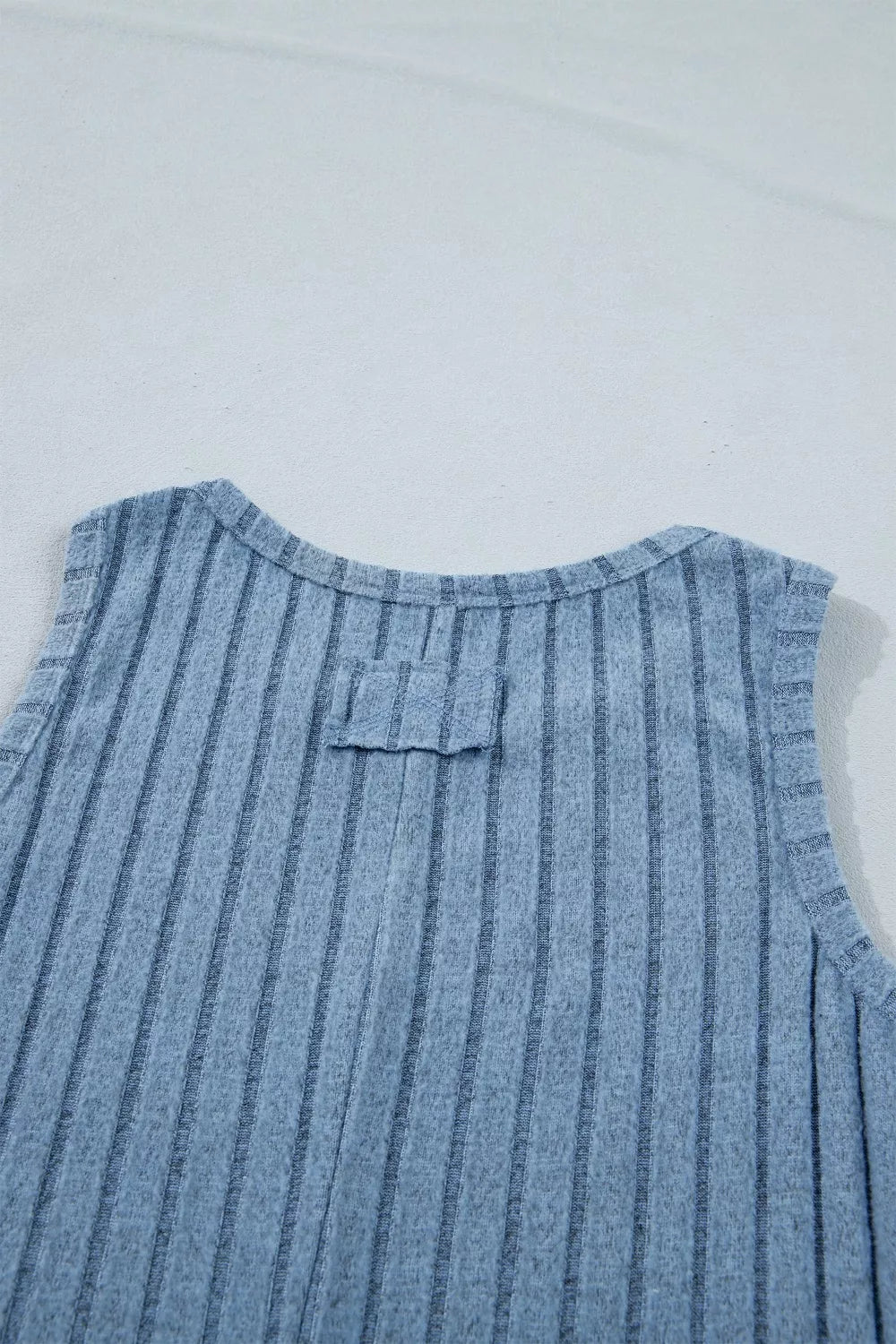 Textured blue mineral wash tank top with vertical ribbing and a bow detail at the back neckline.