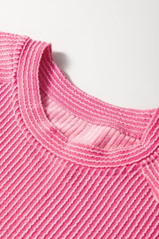 Fuchsia pink ribbed knit co-ord set top with textured stripes and contrast stitching at the neckline.