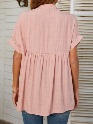 Blush pink linen blend blouse with gathered yoke and short sleeves.