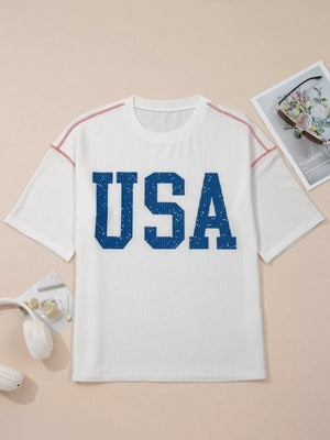 White ribbed t-shirt with blue distressed USA graphic and contrast red stitching.