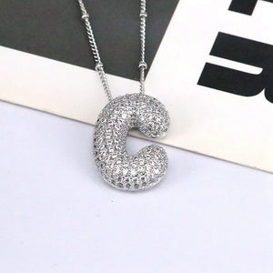 Silver pave initial bubble pendant necklace with letter C charm.