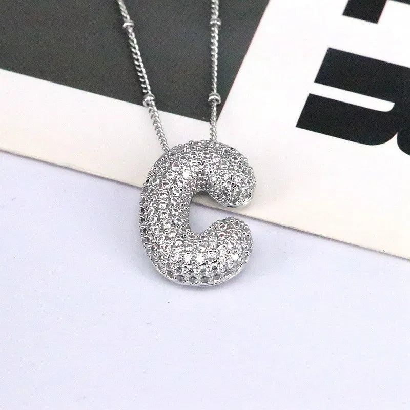 Silver pave initial bubble pendant necklace with letter C charm.