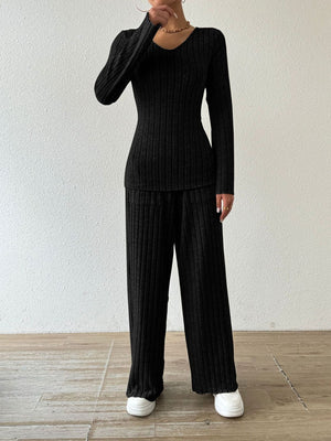Black ribbed knit lounge set with V-neck top and flared pants.