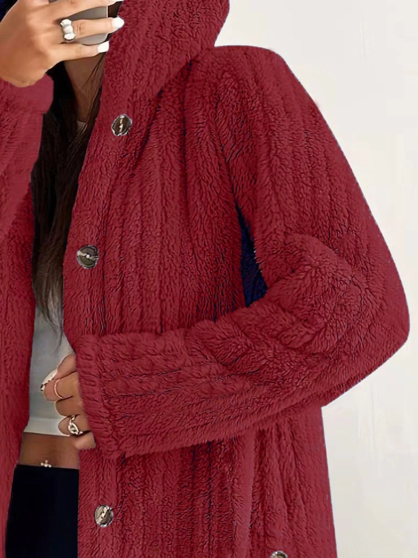 Red button-up fleece jacket with textured fabric and silver buttons.