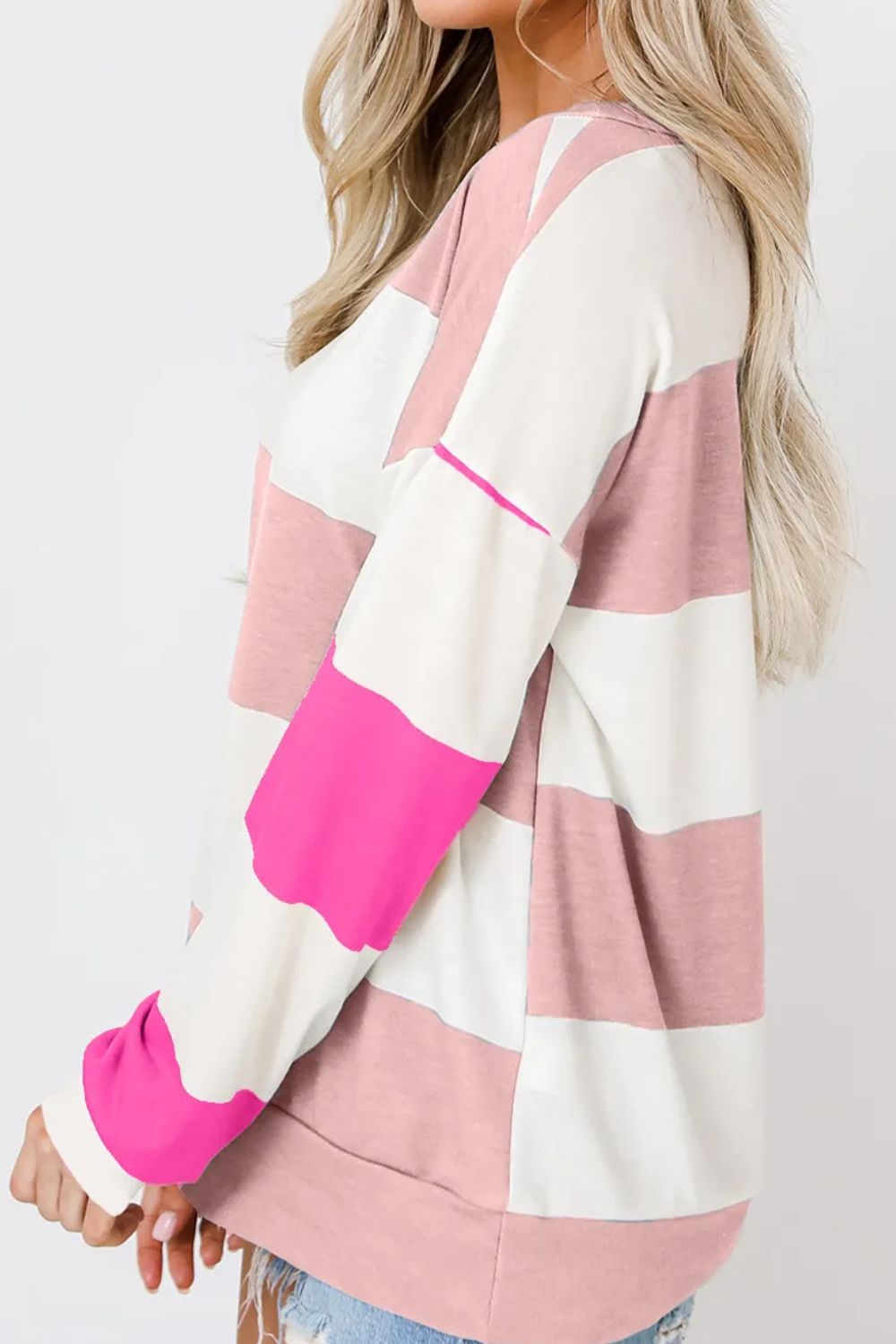 Striped sweatshirt in blush pink, hot pink, and white with block sleeves.