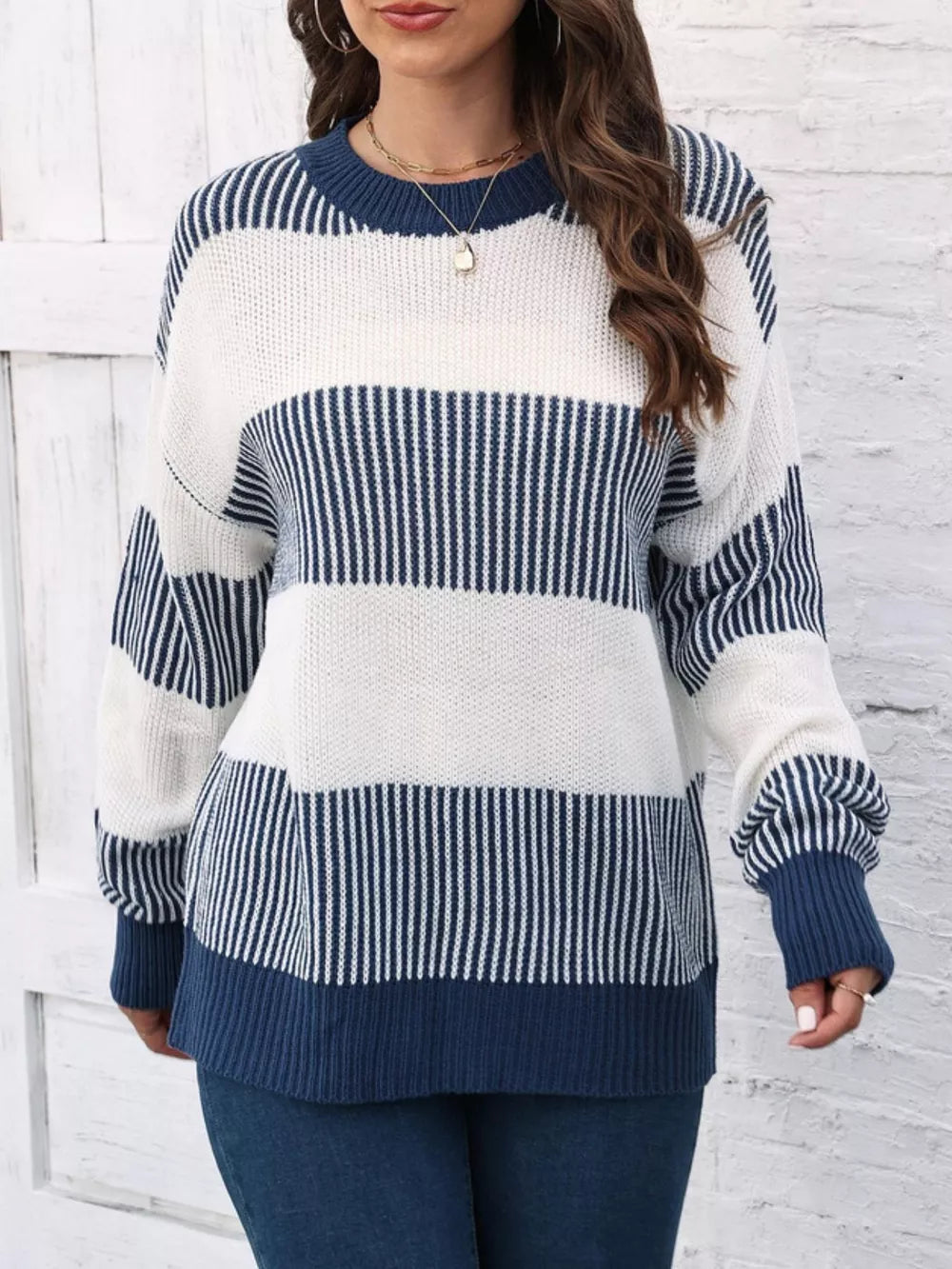 Cozy color block knit sweater with crew neck and long sleeves in dark blue and white stripes.