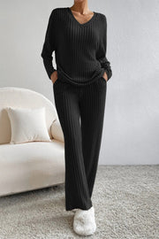 Black ribbed knit lounge set with V-neck top and wide-leg pants.