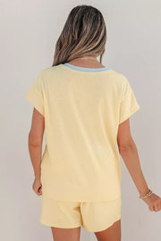 Yellow ribbed cotton two-piece set with crew neck top and shorts, light blue neckline detail.