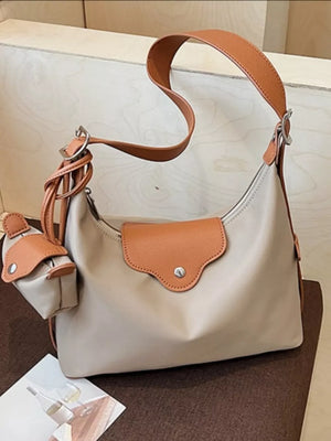 Khaki canvas hobo bag with coin purse and tan leather trim.