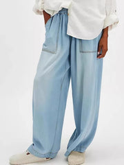 Light blue denim wide-leg pants with elastic waist and patch pockets.
