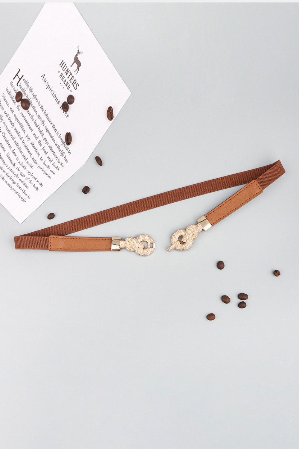 Linked knot elasticated waist belt in caramel with gold alloy buckle detail.