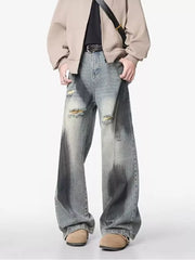 Distressed wide-leg jeans with belt detail, featuring a faded wash and ripped accents.