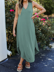 Light green sleeveless V-neck tank midi dress with asymmetrical hemline and side slits.