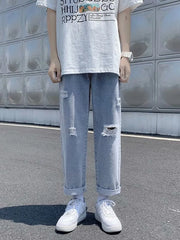 Men's blue distressed relaxed fit jeans with cuffed hem and ripped details.