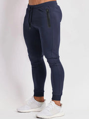 Navy slim fit tech joggers with zip pocket detail and drawstring waist.