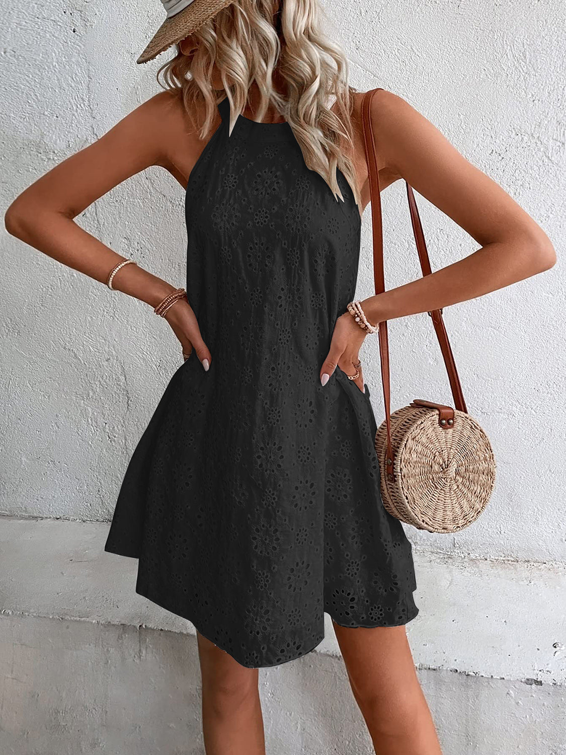 Black halter neck eyelet trapeze mini dress with a flared skirt.