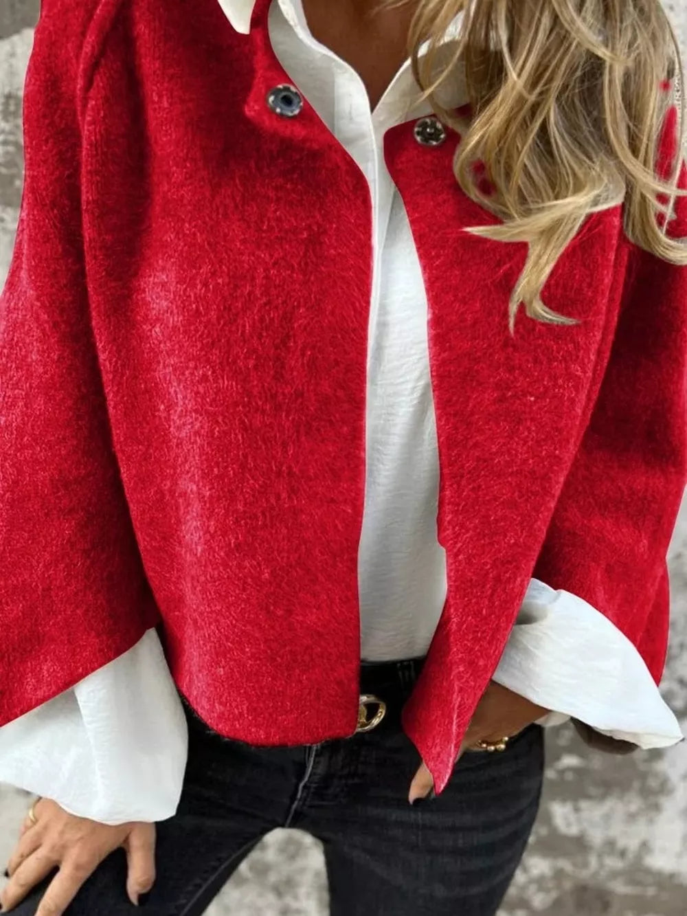 Red fuzzy knit cardigan with button detail, open front, styled with white shirt and jeans.