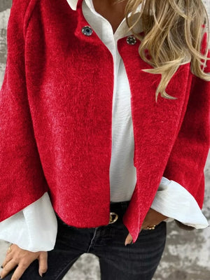 Red fuzzy knit cardigan with button detail, open front, styled with white shirt and jeans.