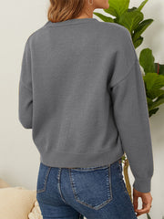 Grey V-neck cardigan with daisy embroidery detail on sleeve cuff.