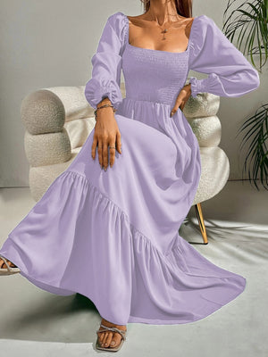 Purple midi dress with smocked bodice, square neck, puff sleeves, and tiered ruffle hem.