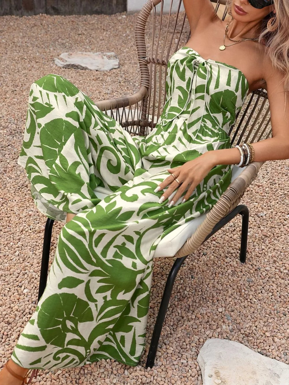 Green tropical print strapless jumpsuit with tie-front detail.