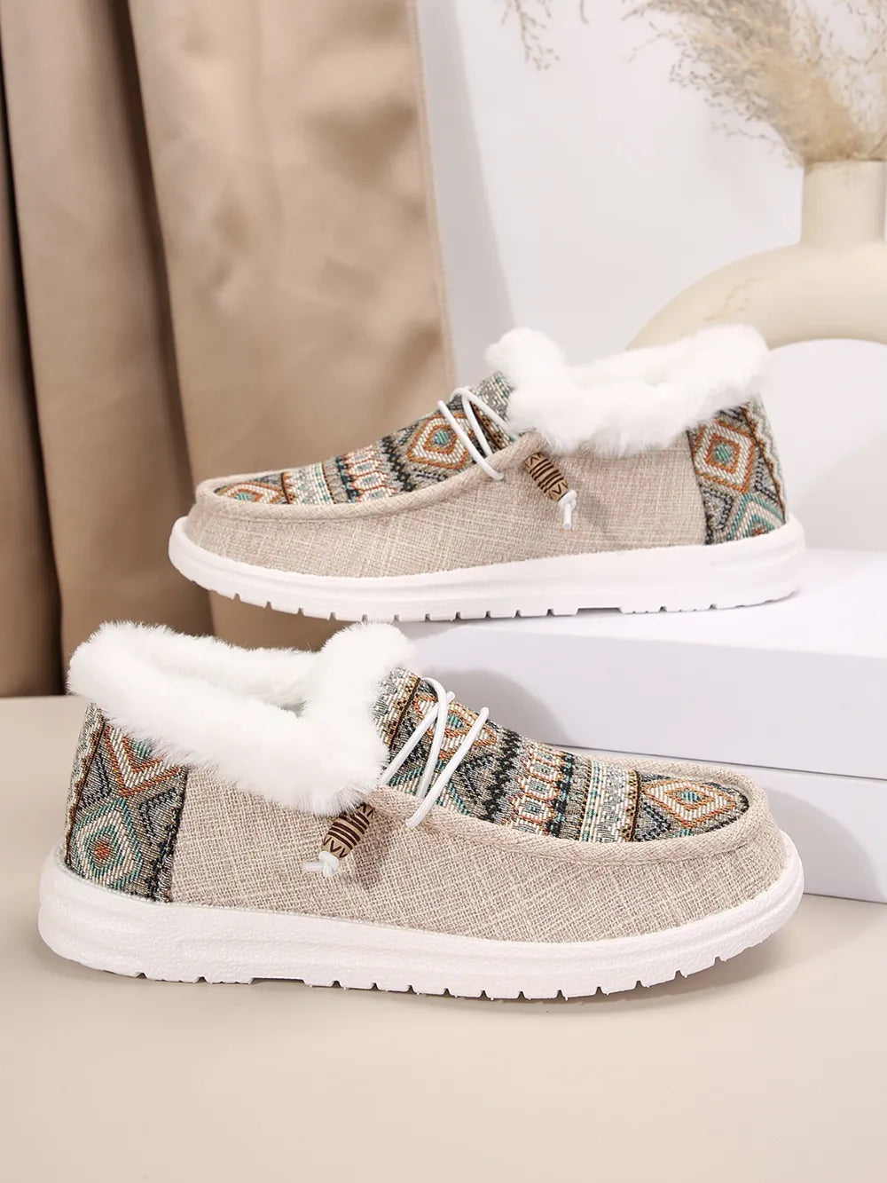 Southwestern print faux fur lined loafers in taupe with white laces and trim.
