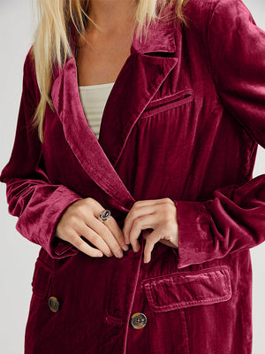 Burgundy velvet double-breasted blazer with patch pockets and button closure.