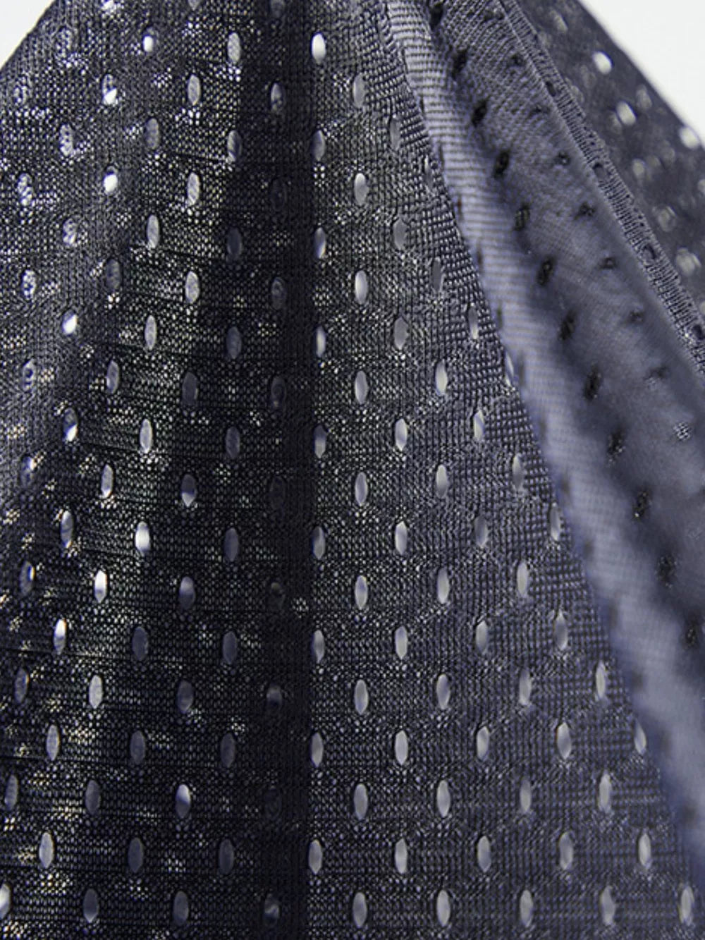 Dark blue mesh men's vest with oval perforations, showing fabric detail.