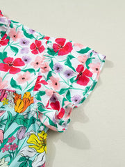 Vibrant floral maternity overshirt with flutter sleeves and ruffled trim.