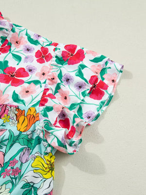 Vibrant floral maternity overshirt with flutter sleeves and ruffled trim.